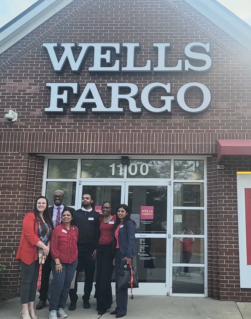Wells Fargo workers stand outside their branch